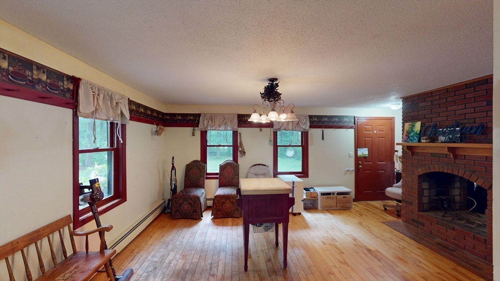 330 Arbor Street Lunenburg, MA 01462 - Photo 10 of 33 a living room with furniture and a fireplace