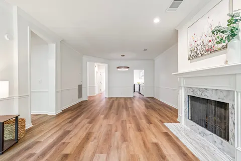 a view of a room with wooden floor staircase and a hallway