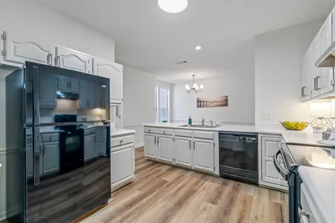 a kitchen with a sink appliances and cabinets