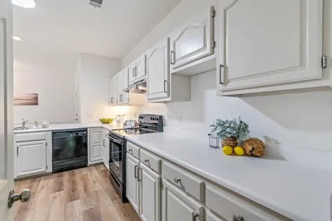 a kitchen with stainless steel appliances a sink and refrigerator