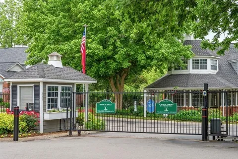 a front view of a house with a garden and plants