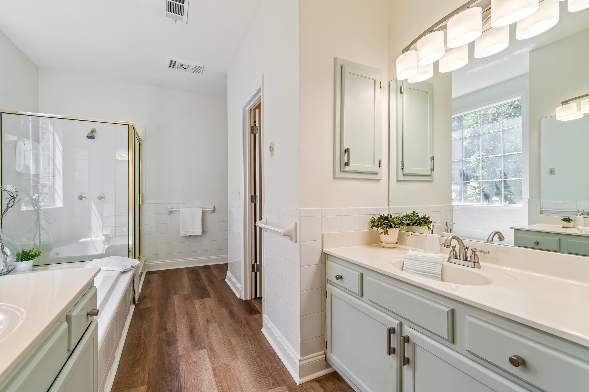 231 Green Harbor Road, Unit 113A Old Hickory, TN 37138 - Photo 36 of 60 a bathroom with a sink a large mirror a vanity and shower