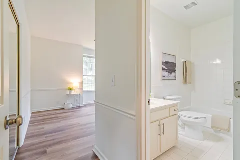 a bathroom with a granite countertop sink a toilet and a bathtub