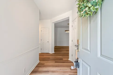 a view of an entryway with wooden floor