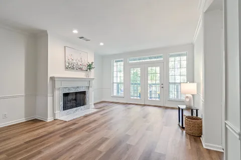 a view of empty room with wooden floor and fireplace
