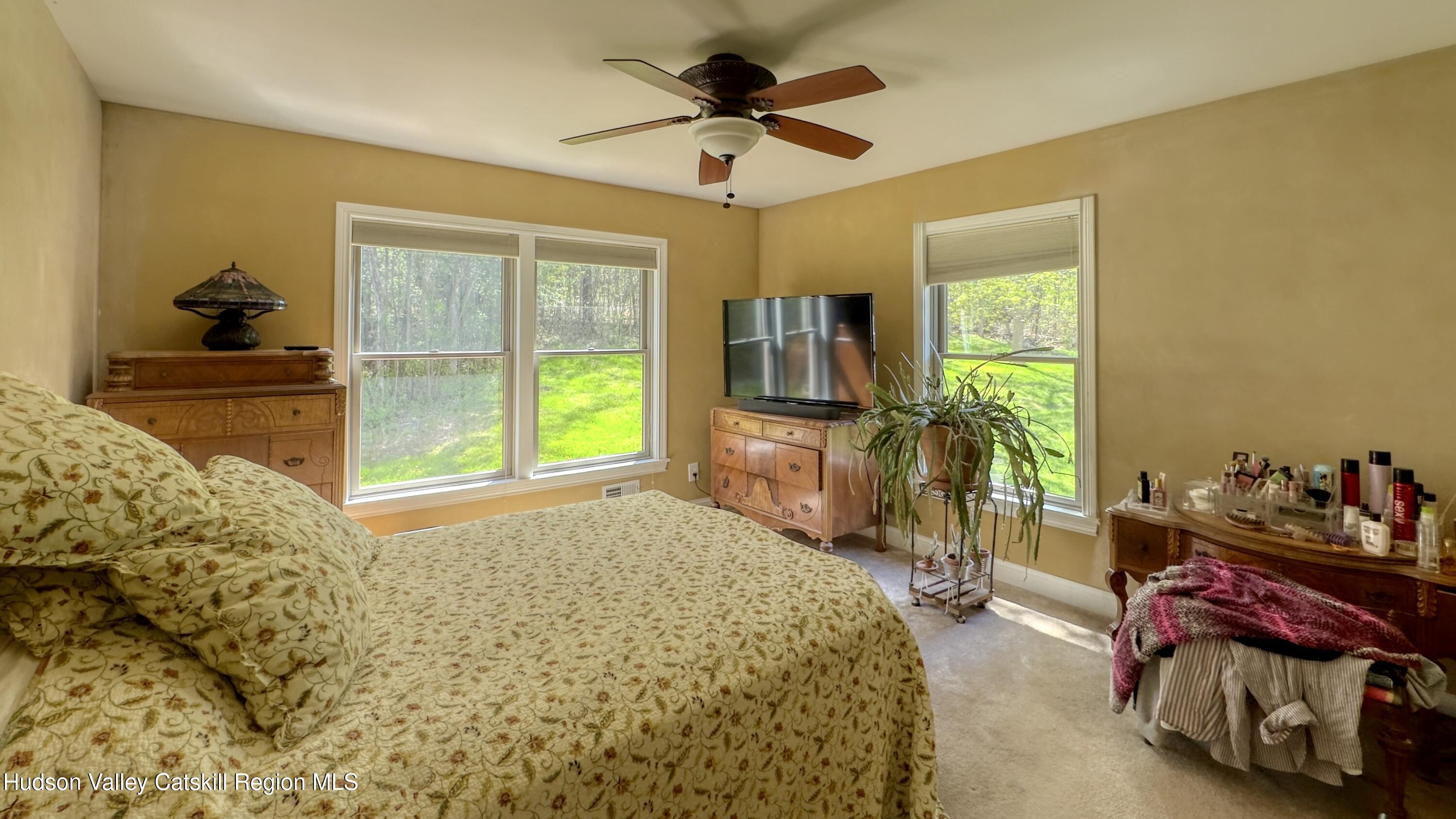 996 Sleepy Hollow Road Athens, NY 12015 - Photo 11 of 32 a bed room with a bed and a chandelier