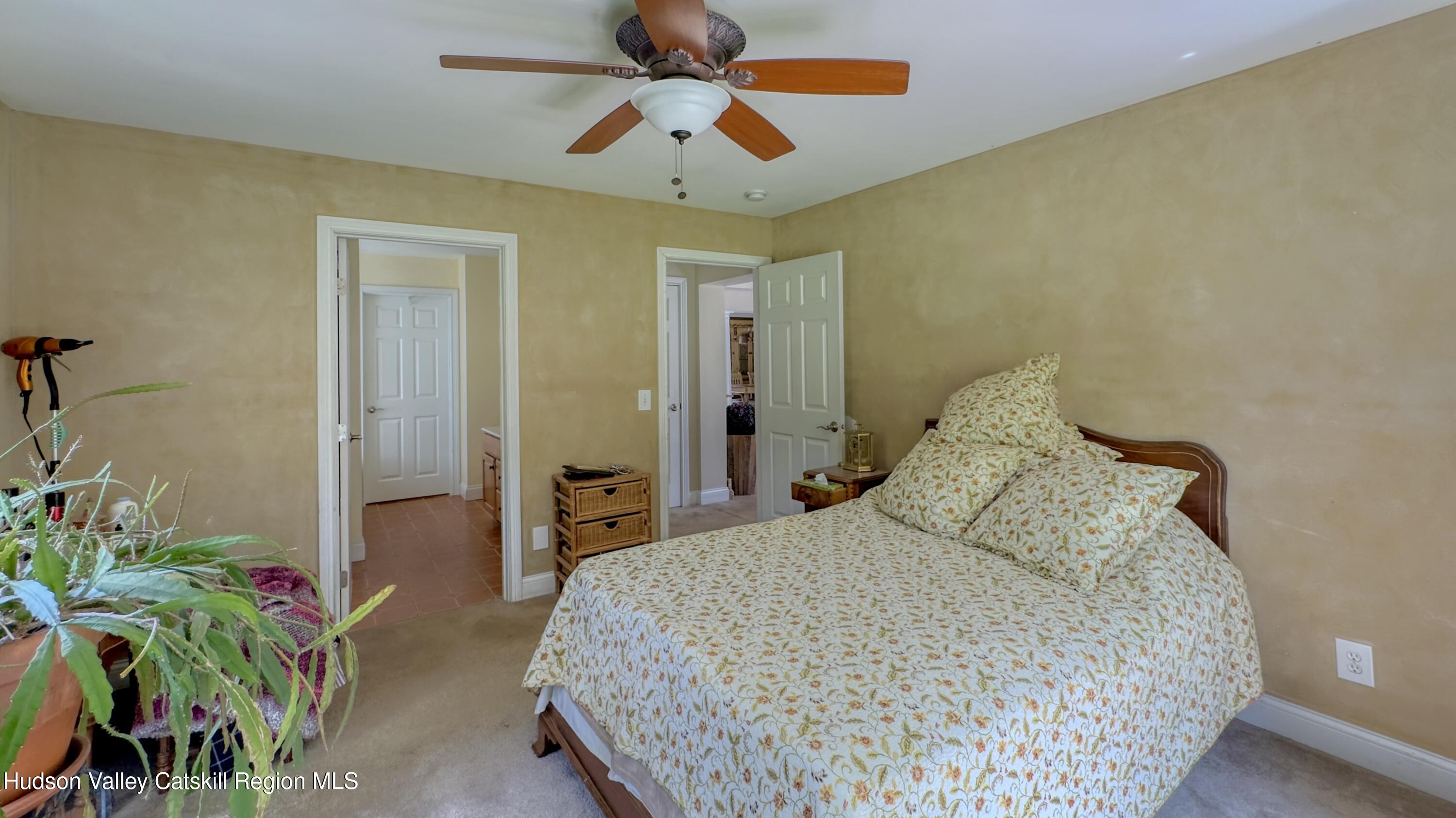 996 Sleepy Hollow Road Athens, NY 12015 - Photo 16 of 32 a bedroom with a bed and a potted plant
