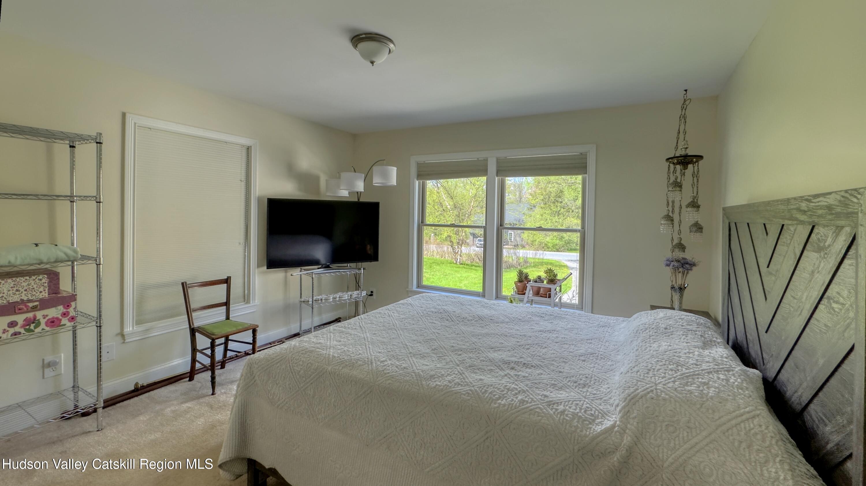 996 Sleepy Hollow Road Athens, NY 12015 - Photo 17 of 32 a bedroom with a bed and a flat screen tv