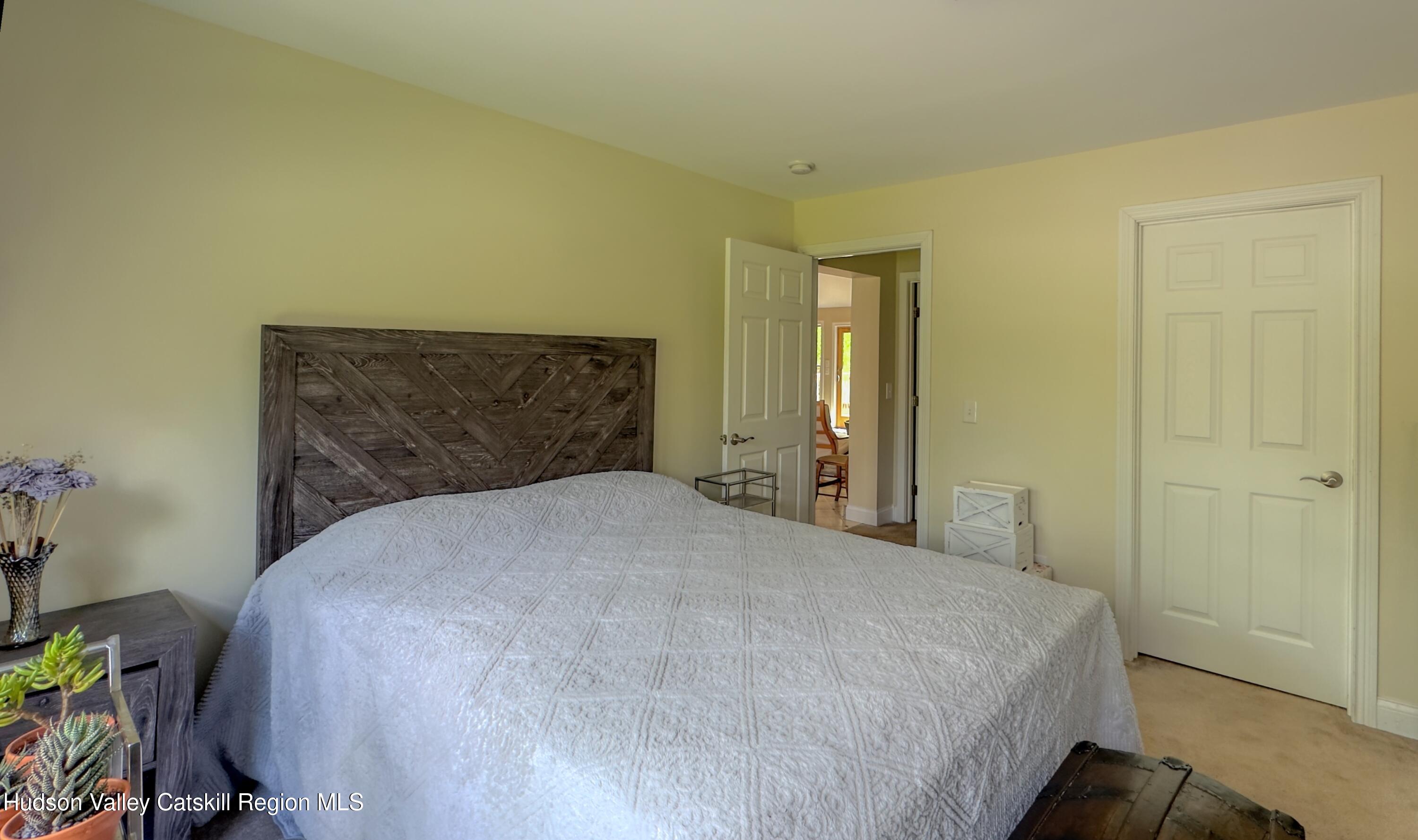 996 Sleepy Hollow Road Athens, NY 12015 - Photo 18 of 32 a bedroom with a bed and a potted plant