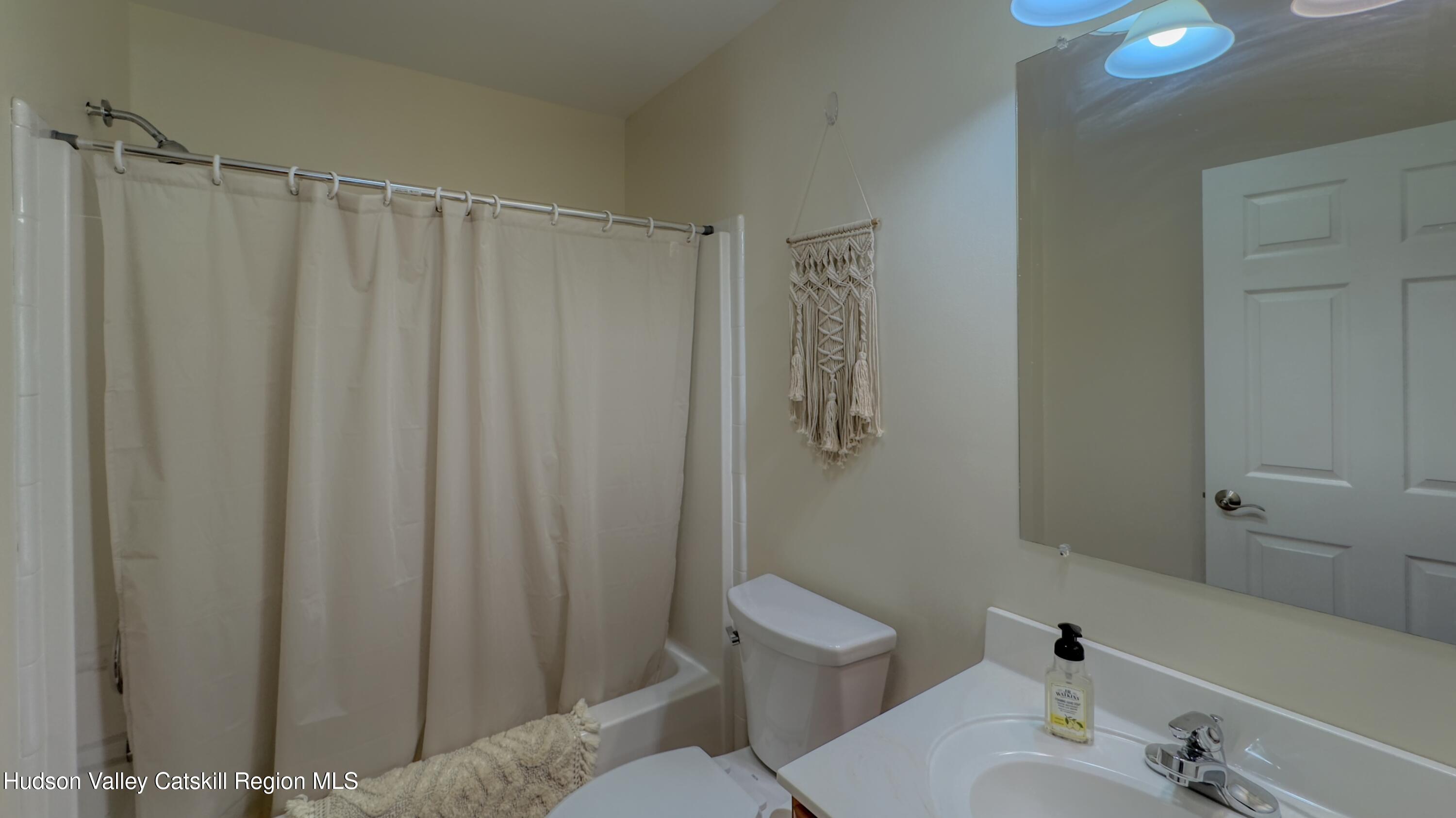 996 Sleepy Hollow Road Athens, NY 12015 - Photo 20 of 32 a bathroom with a shower curtain and a sink