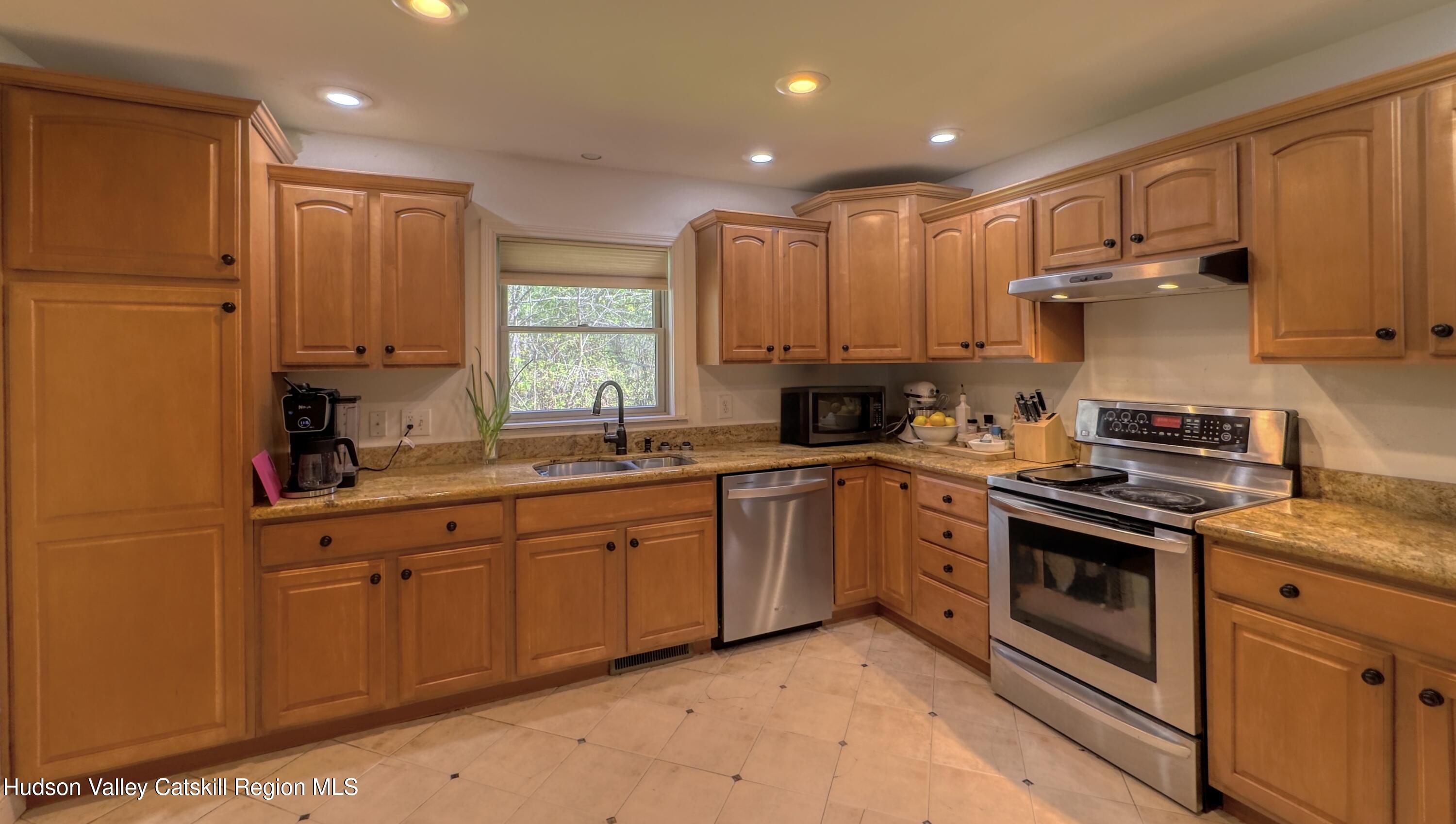 996 Sleepy Hollow Road Athens, NY 12015 - Photo 21 of 32 a kitchen with stainless steel appliances granite countertop a stove sink and cabinets