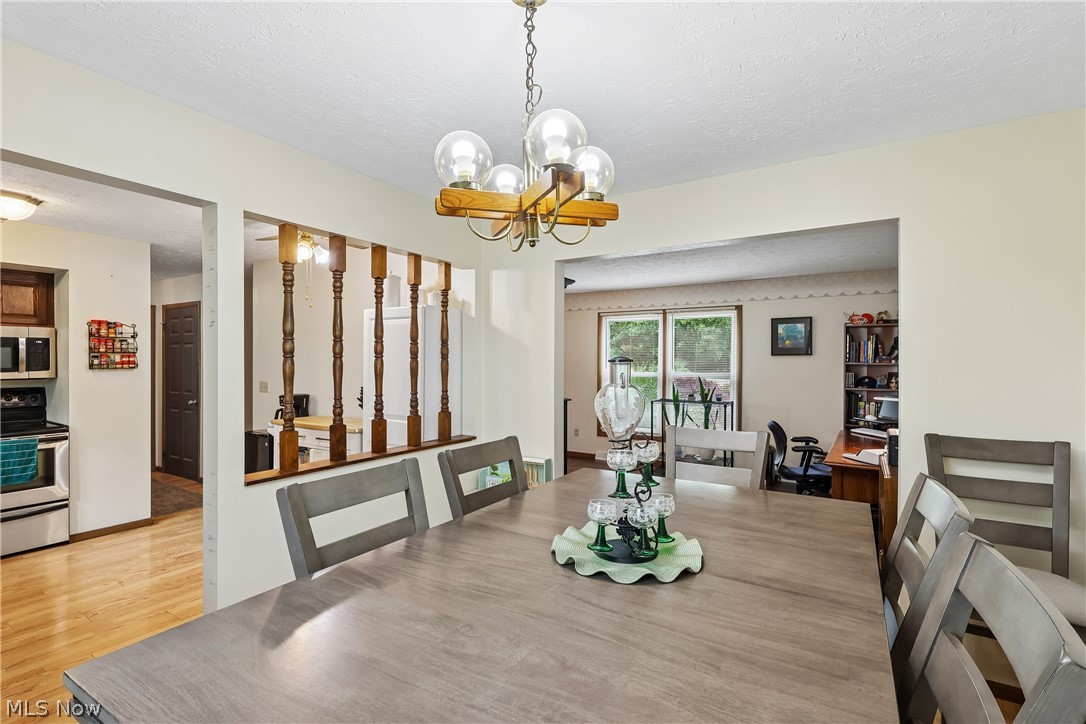 4702 Alger Road Richfield, OH 44286 - Photo 14 of 46 Dining room with chandelier, looking into kitchen and living room