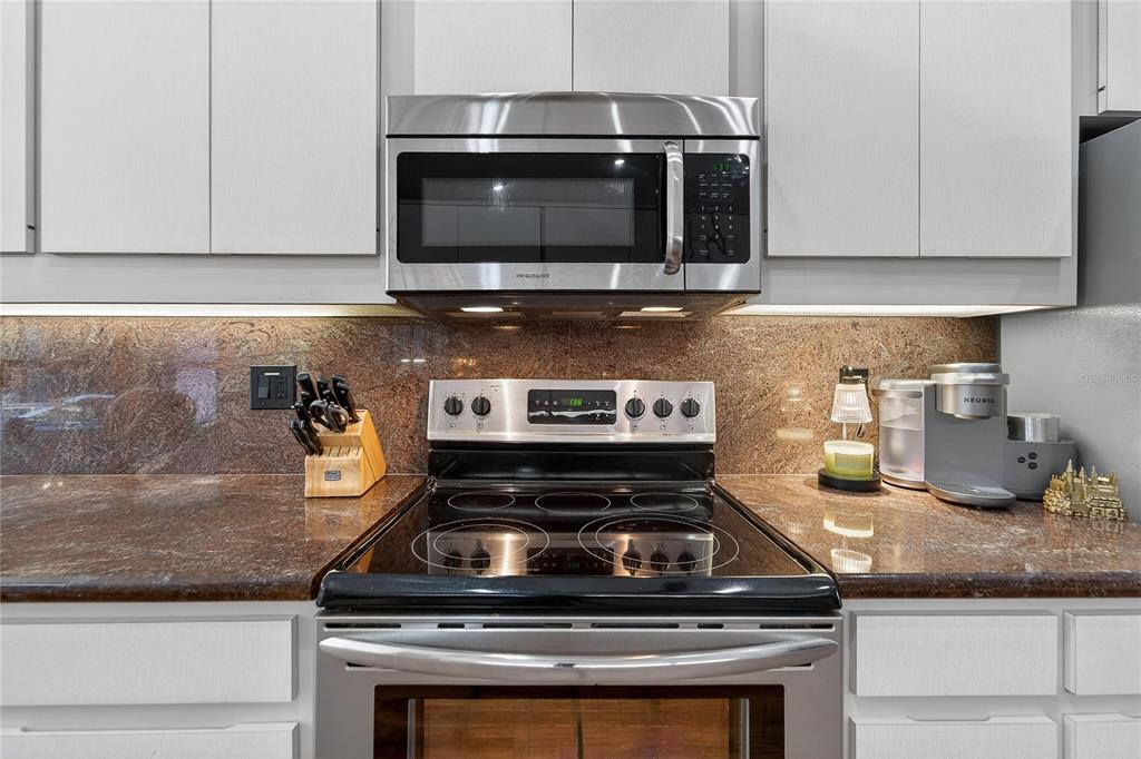 23 Chinkapin Circle Homosassa, FL 34446 - Photo 24 of 69 a kitchen with granite countertop a stove and a microwave