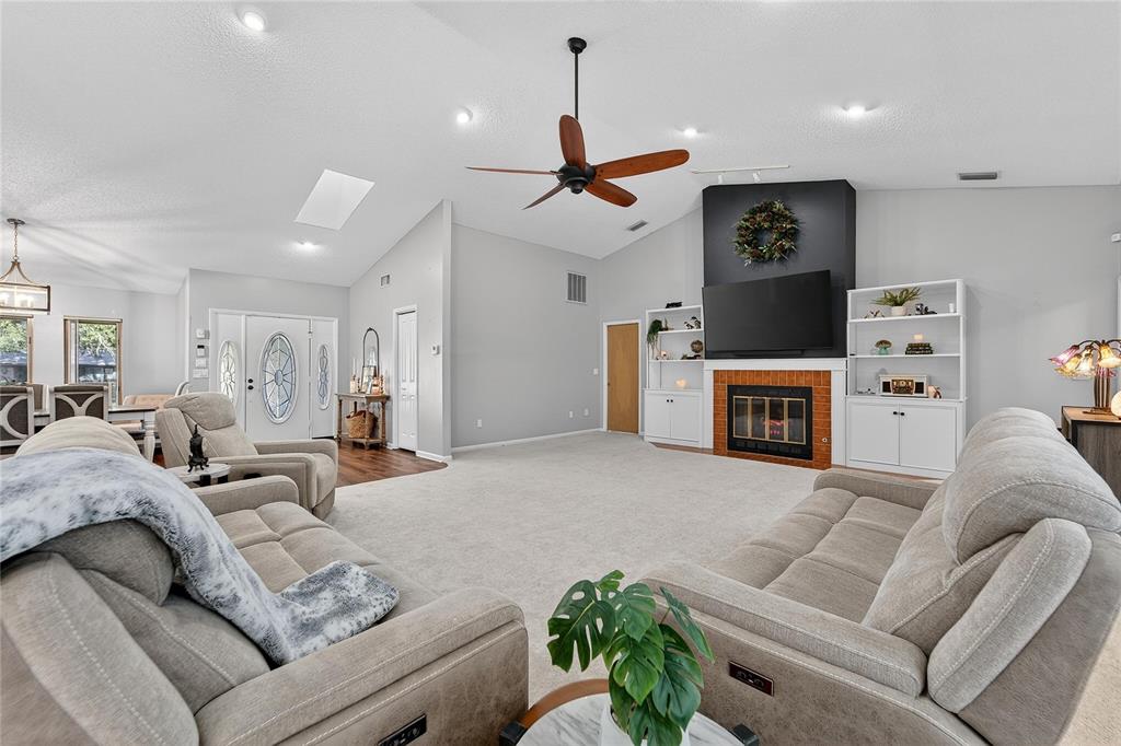 23 Chinkapin Circle Homosassa, FL 34446 - Photo 3 of 69 a living room with furniture a fireplace and a chandelier