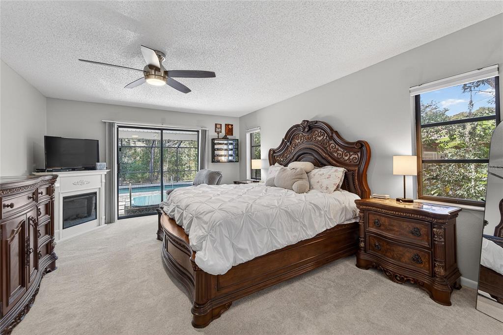 23 Chinkapin Circle Homosassa, FL 34446 - Photo 31 of 69 a spacious bedroom with a bed and a flat tv screen on dresser