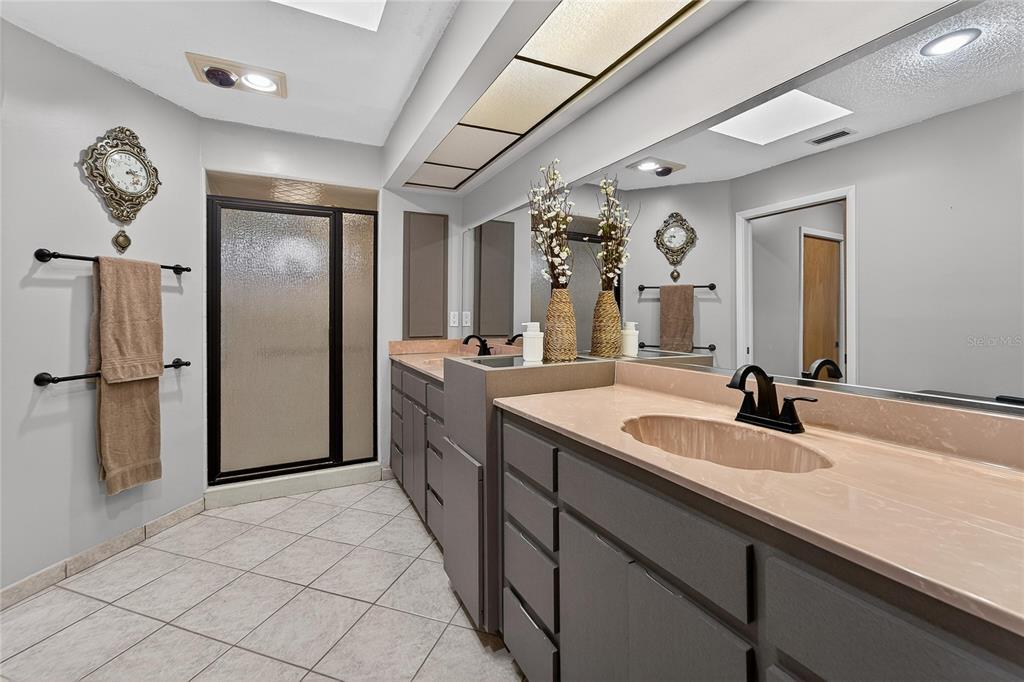 23 Chinkapin Circle Homosassa, FL 34446 - Photo 36 of 69 a bathroom with a sink a mirror and a shower