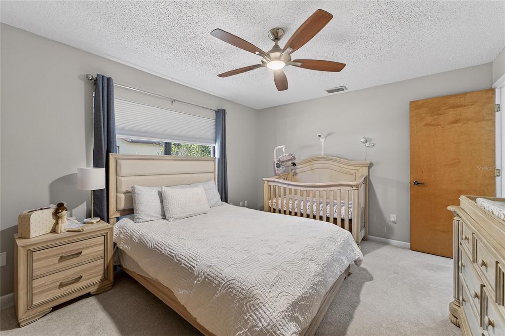 23 Chinkapin Circle Homosassa, FL 34446 - Photo 47 of 69 a bedroom with a large bed and a chandelier