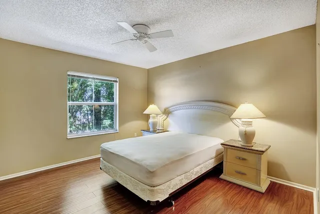 a bedroom with a bed and a night stand