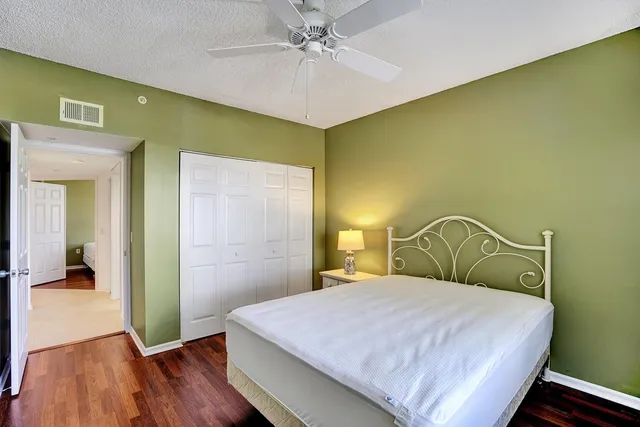 a bedroom with a bed and a ceiling fan