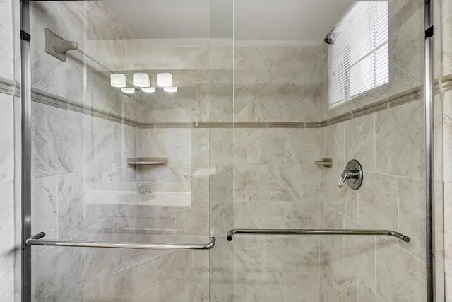 a bathroom with a glass shower door
