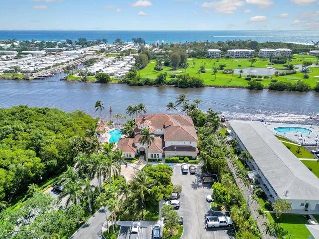 an aerial view of a house with a garden and lake view