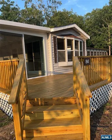 a view of a house with wooden floor and a yard