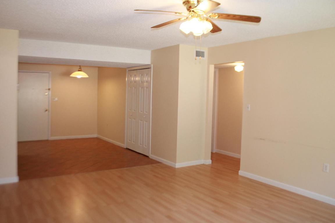 609 Colonial Drive, Unit 2 Fort Walton Beach, FL 32547 - Photo 13 of 17 an empty room with wooden floor fan and windows