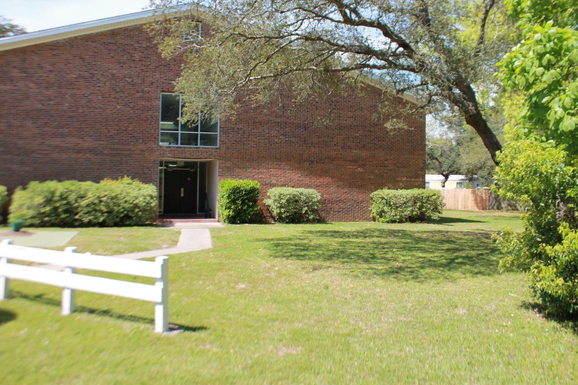 609 Colonial Drive, Unit 2 Fort Walton Beach, FL 32547 - Photo 15 of 17 a front view of a house with a yard and garage