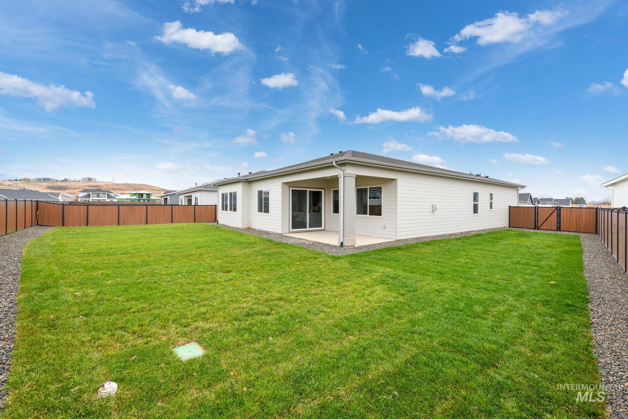 3612 North Pindall Way Star, ID 83669 - Photo 12 of 12 Back of house with a patio, a fenced backyard, and a gate