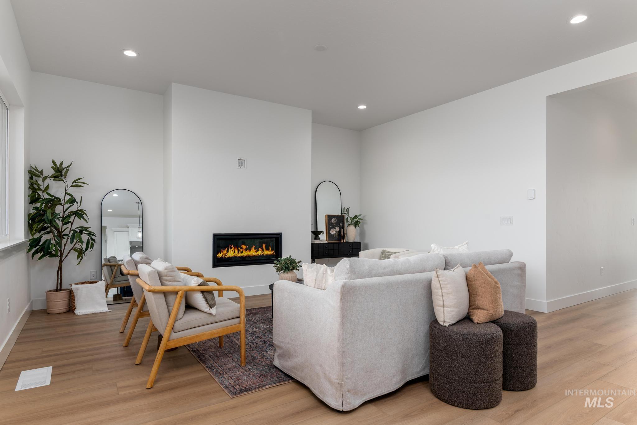 3612 North Pindall Way Star, ID 83669 - Photo 2 of 12 Living room featuring recessed lighting, light wood finished floors, and a glass covered fireplace