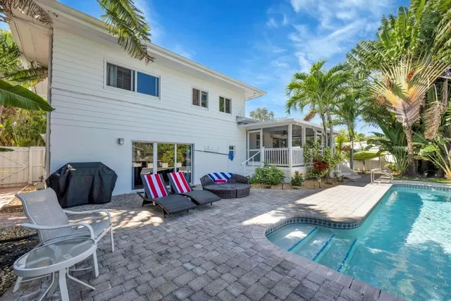 a view of a backyard with sitting area