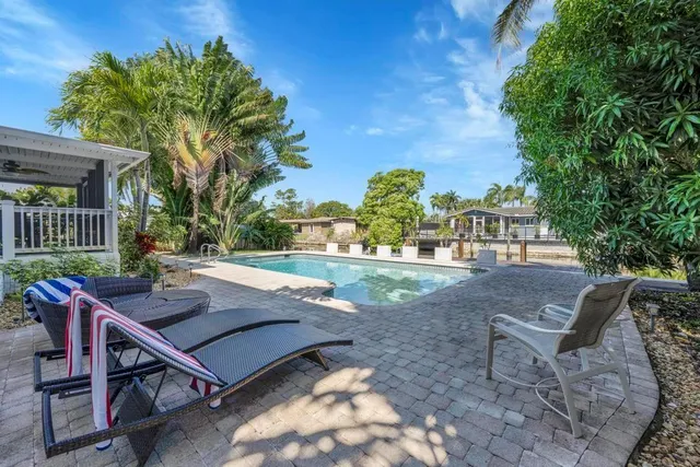 a bathroom with a granite countertop sink a mirror and a shower