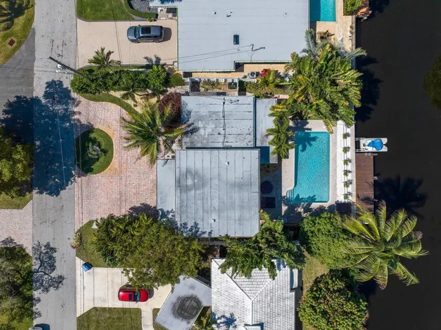 an aerial view of a house with swimming pool outdoor seating and lake view