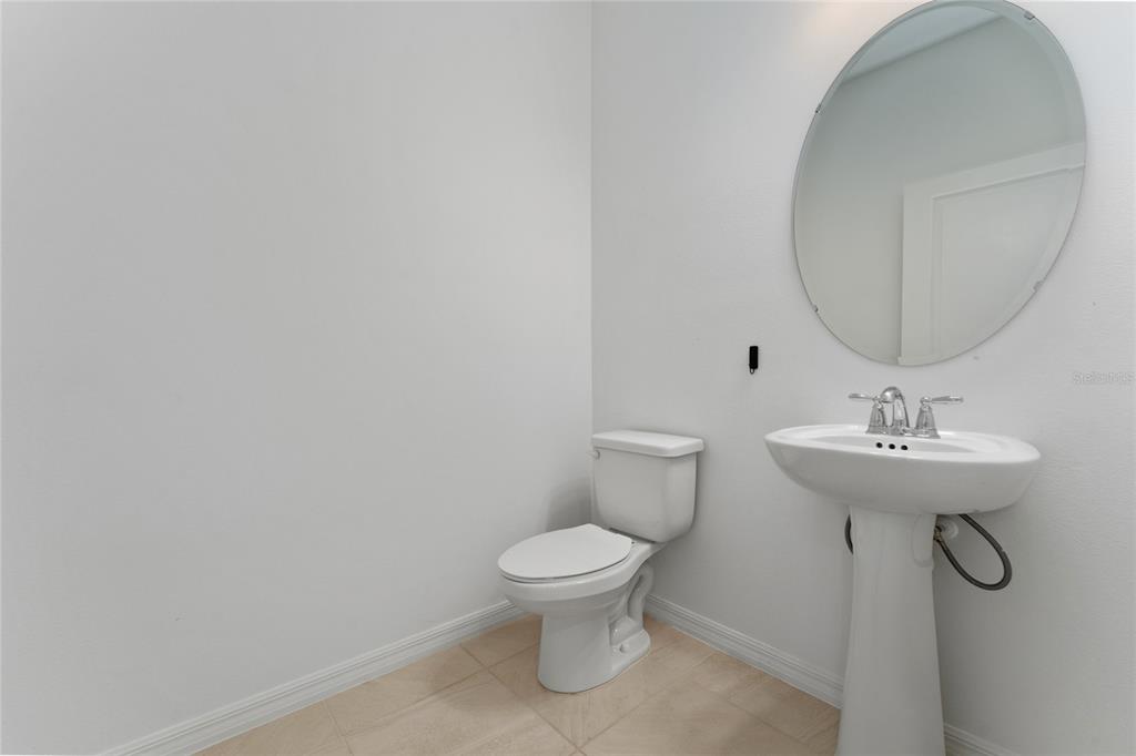 2834 High Pointe Circle Clermont, FL 34711 - Photo 12 of 39 a bathroom with a toilet a sink and mirror