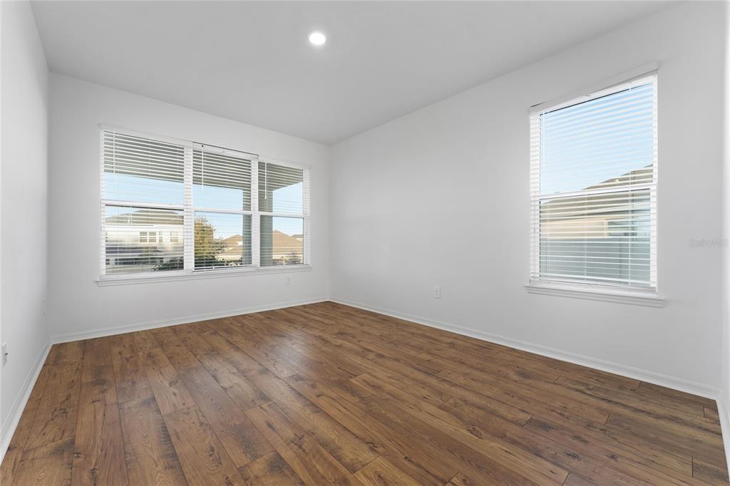 2834 High Pointe Circle Clermont, FL 34711 - Photo 13 of 39 a view of an empty room with wooden floor and a window