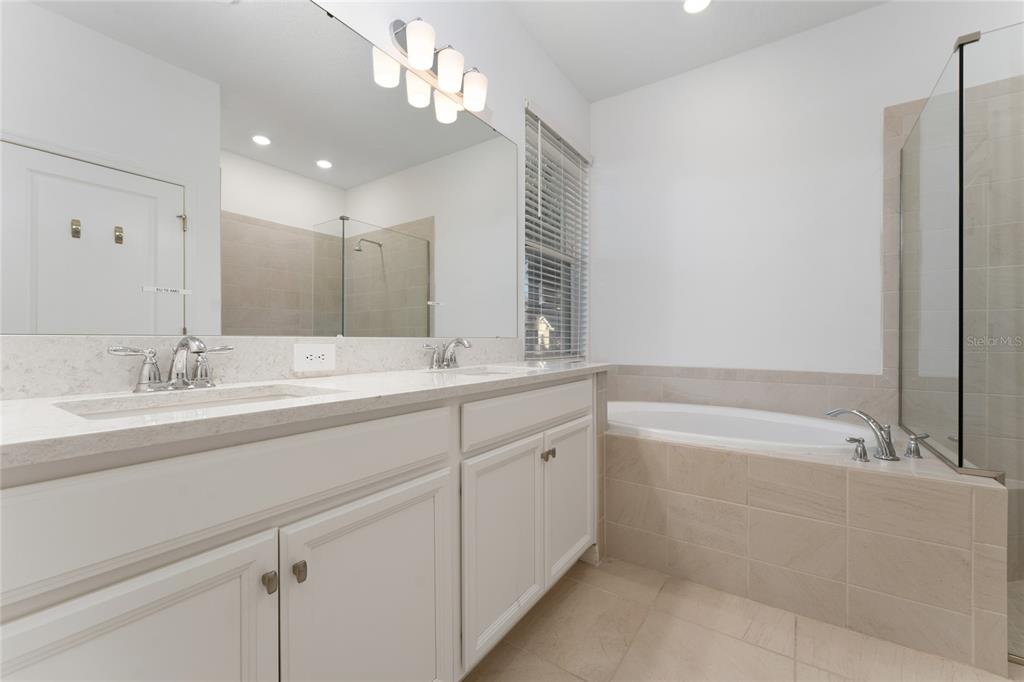 2834 High Pointe Circle Clermont, FL 34711 - Photo 15 of 39 a spacious bathroom with a double vanity sink mirror and bathtub
