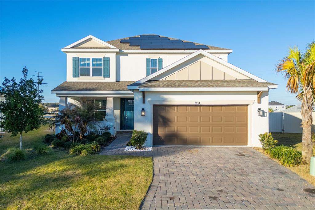 2834 High Pointe Circle Clermont, FL 34711 - Photo 2 of 39 a front view of a house with a yard and garage