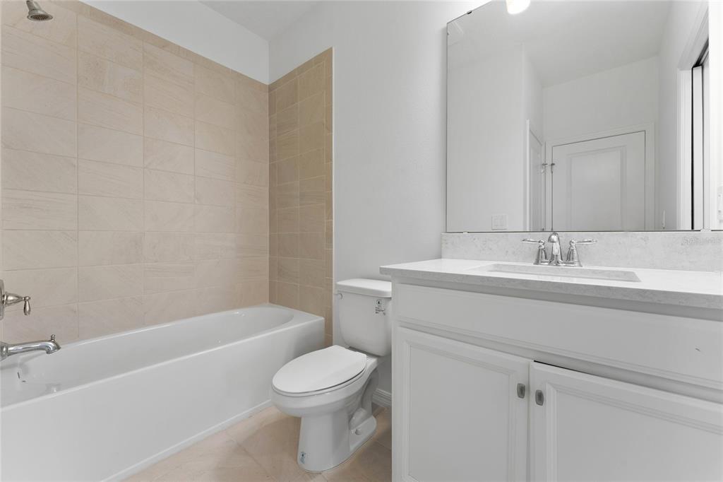 2834 High Pointe Circle Clermont, FL 34711 - Photo 21 of 39 a bathroom with a bathtub shower sink vanity and toilet