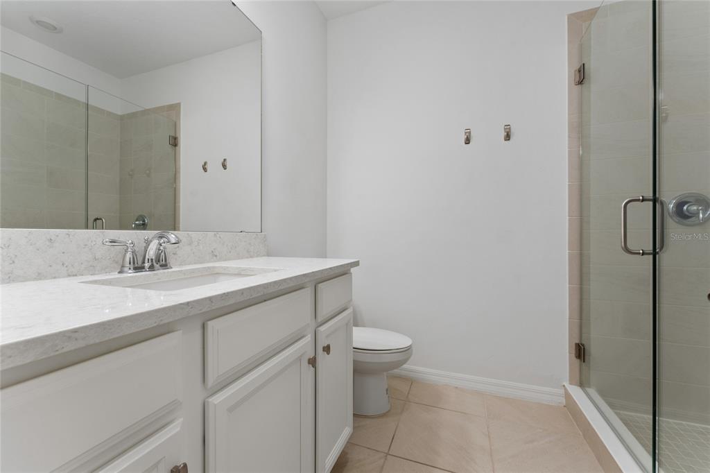 2834 High Pointe Circle Clermont, FL 34711 - Photo 28 of 39 a bathroom with a granite countertop sink toilet and shower