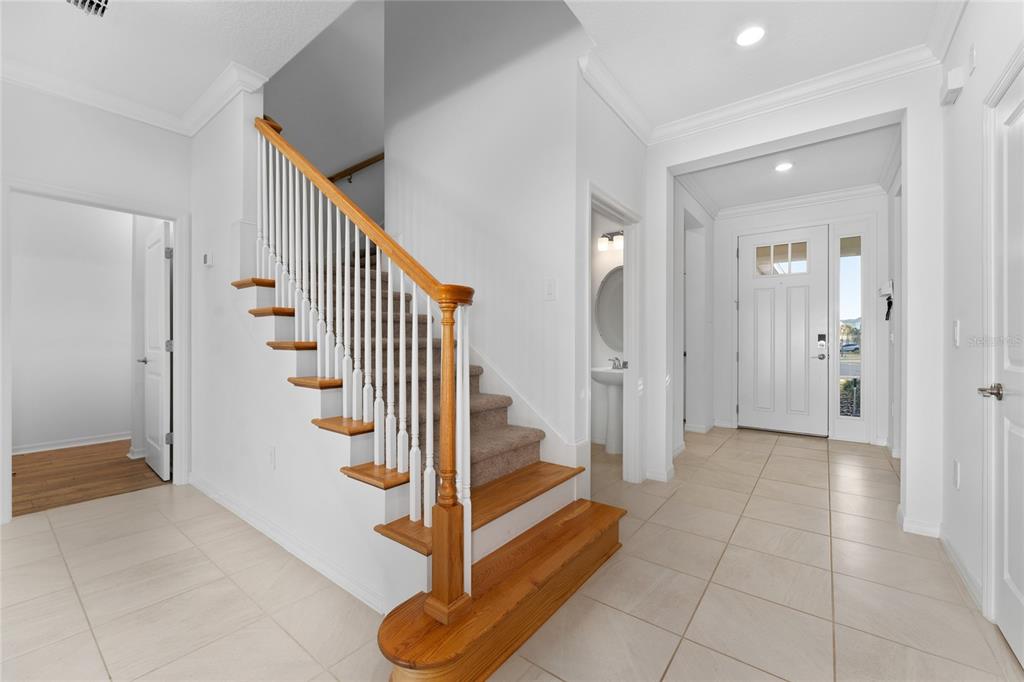 2834 High Pointe Circle Clermont, FL 34711 - Photo 3 of 39 a view of entryway with wooden floor and stairs