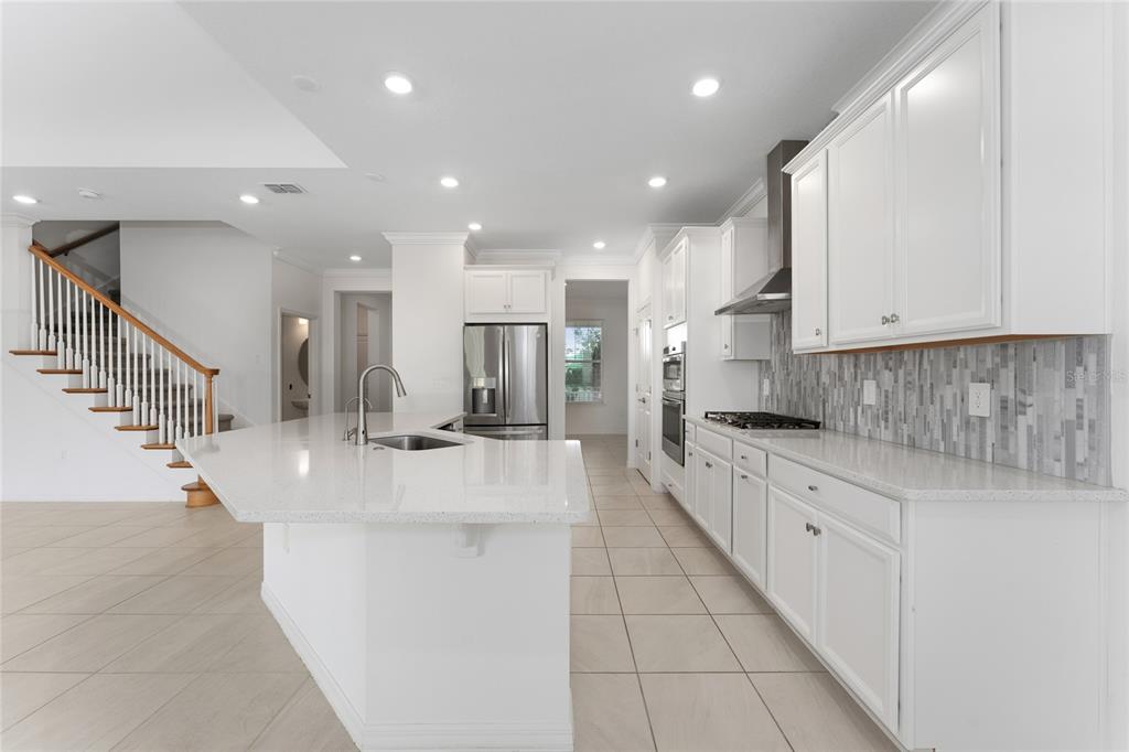 2834 High Pointe Circle Clermont, FL 34711 - Photo 5 of 39 a large kitchen with stainless steel appliances granite countertop a large counter top and a stove
