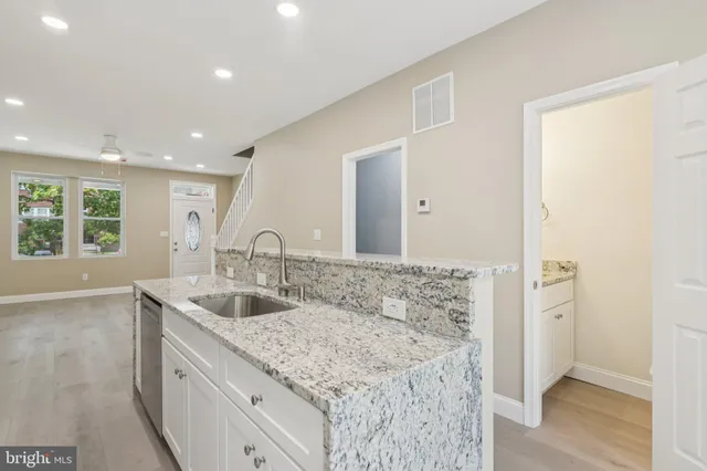 a kitchen with appliances a sink and cabinets