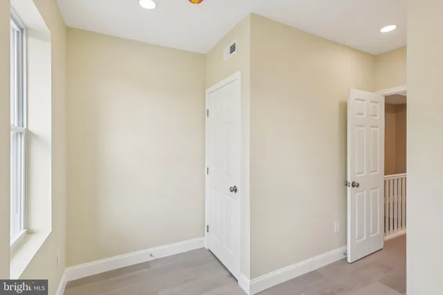 a bathroom with a granite countertop toilet a sink and shower