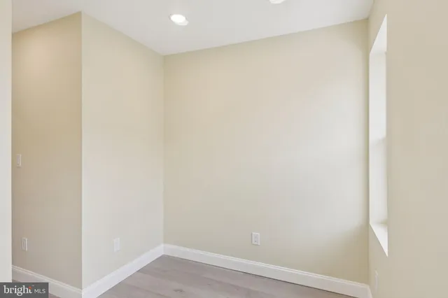 a view of a room with wooden floor and window