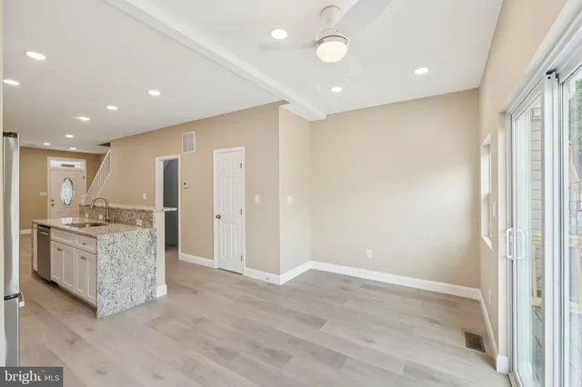 a kitchen with stainless steel appliances granite countertop a refrigerator stove microwave and sink