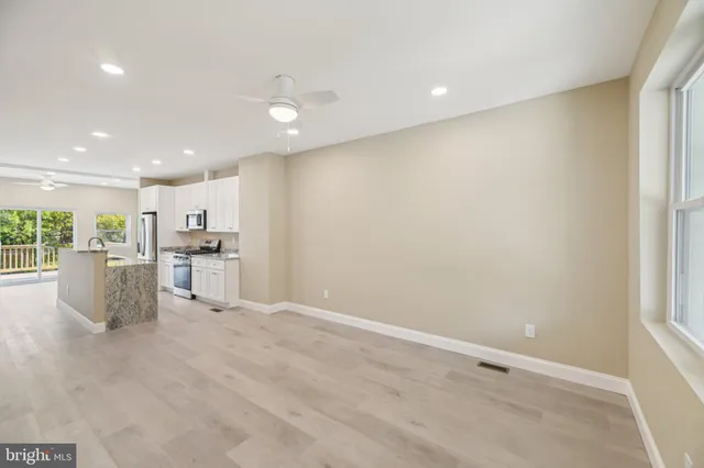 a view of a sink and cabinets with wooden floor