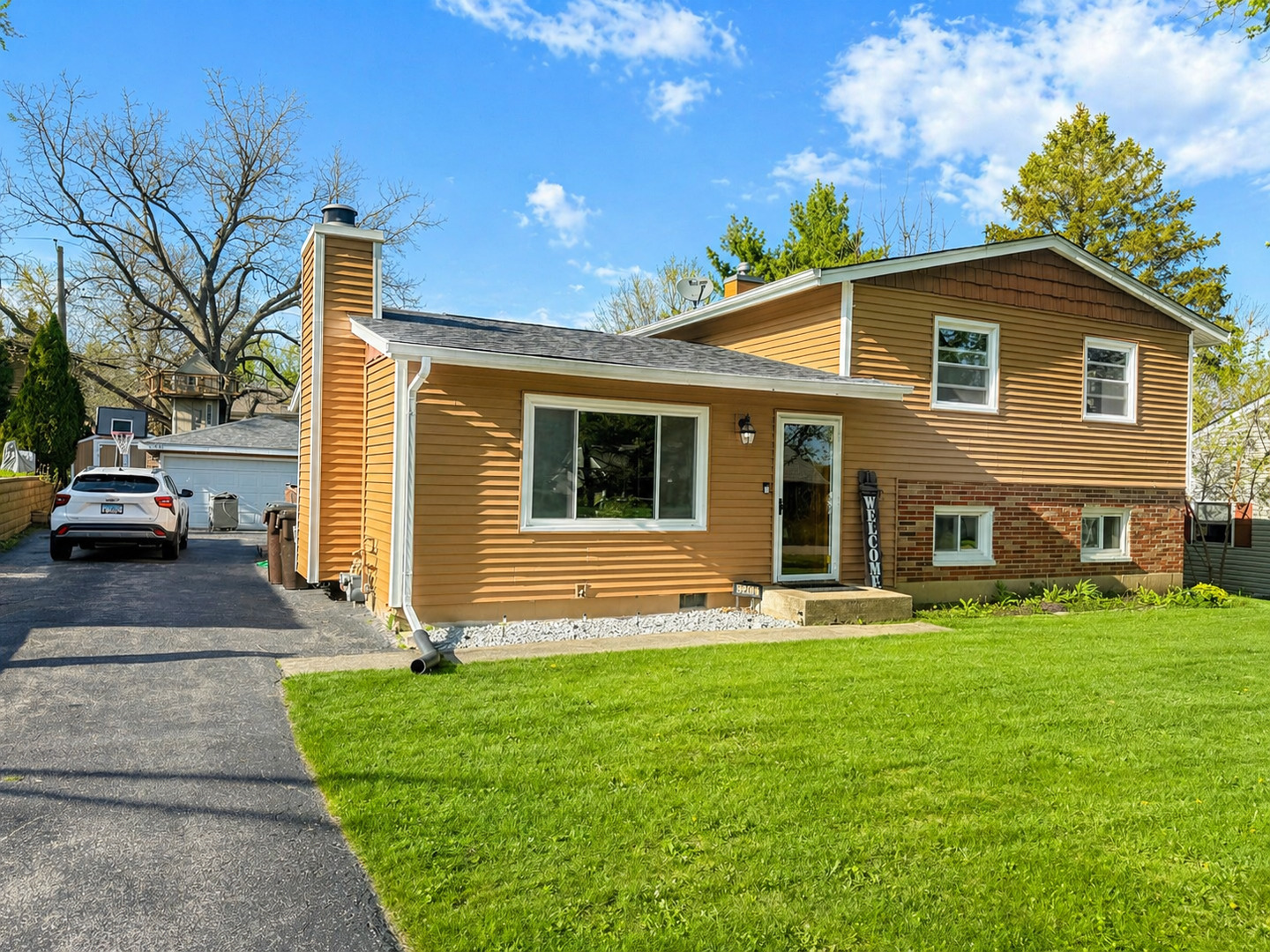 a front view of a house with a yard and garage