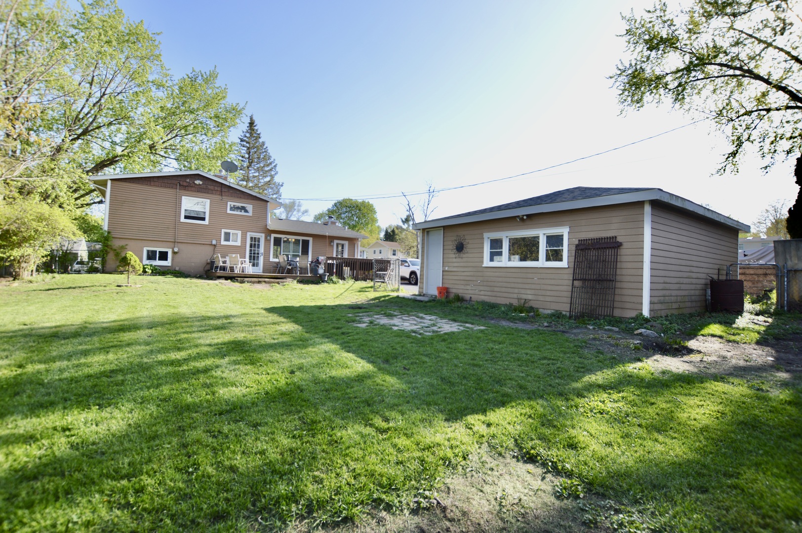 3206 Hunter Path McHenry, IL 60050 - Photo 2 of 13 a view of a house with a big yard and large trees