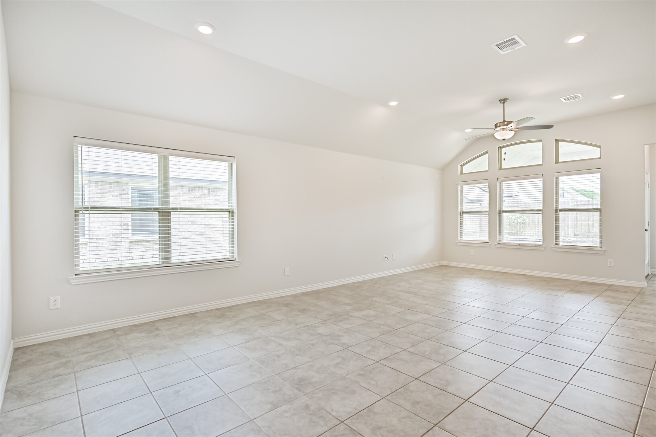 7019 Terra Drive Manvel, TX 77578 - Photo 14 of 41 an empty room with windows and chandelier