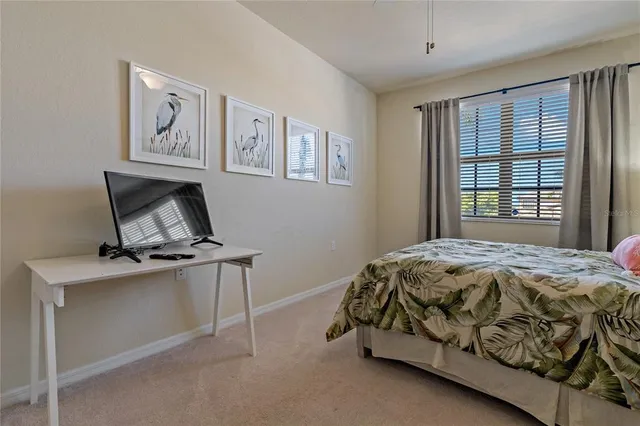 a bedroom with a large bed and a chandelier